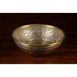 A Small Islamic Brass Bowl inlaid with silver & copper decoration and having a band of script to