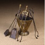 A 19th Century Embossed Sheet Brass Coal Bucket of tapering oval form on a raised foot with