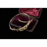 A 15 Carat Gold Crescent Brooch set with seed pearls and housing in a burgundy velvet lined