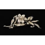 A Fabulous Floral Spray Brooch encrusted with diamonds and having a flower-head en tremblant on a