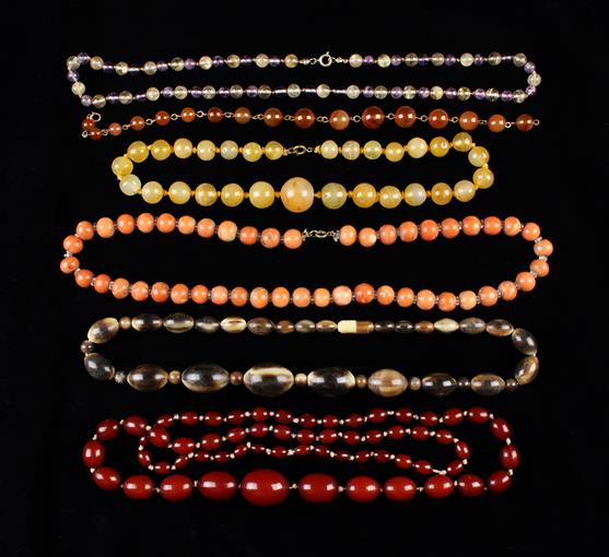 Six Vintage Bead Necklaces: A continuous string of graduated oval simulated cherry amber beads 37"