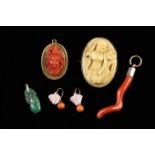 An Antique Coral Cameo Brooch carved in high relief with a bacchante wreathed in fruiting vine in a