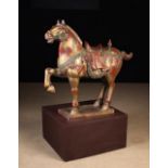 A Carved Wooden Tang Style Horse decorated with red & green paintwork enhanced with gilding and