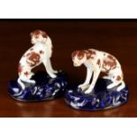 A Pair of Late 19th Century Porcelain Dogs sat on domed oval bases of deep rich blue glaze.