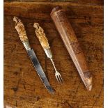 An 18th/19th Century Fruit Knife & Fork with carved boxwood handles in a tooled leather scabbard.