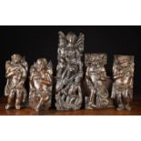 A Group of Five 17th Century Carved Figural Appliqués: Four depicting curly haired cherubs with