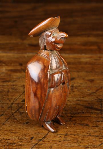 A Late 18th Century Whimsical Carved Nut Snuff Box in the form of a caricature priest depicted