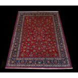 A Persian Sherkat Mashad Carpet woven in wool with silk highlights with an allover design of