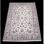 A Persian Sherkat Mashad Carpet woven in wool with silk highlights with an allover design of