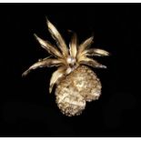A Charming Bouche Gold Coloured Pineapple Brooch with glass chips and a faux pearl as decoration.