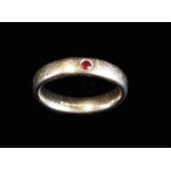 A Charming 18ct White Gold Ladies Ring with a small Ruby inset into the band.