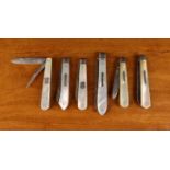 Six Folding Silver Fruit Knives with mother-of-pearl clad handles: One with folding pick hallmarked
