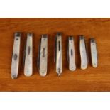 A Group of Six Antique Folding Silver Fruit Knives with mother of pearl clad handles & a Georgian