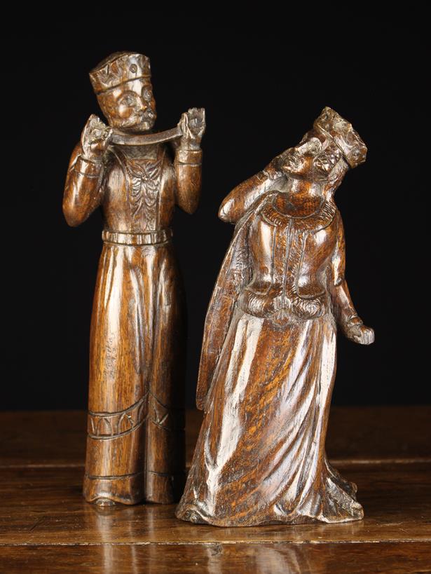 A Pair of 19th Century Oak Figure Carvings: A Medieval king stood holding a strap,