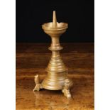 A Neo Gothic Bronze Pricket Candlestick with a round crenulated drip pan on a blade knopped stems