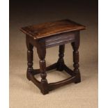 A 19th/20th Century Oak Joint Stool with deep run moulded frieze rails on turned legs united by