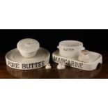 Two Grocer's Shop Ceramic Stands labelled in black 'BUTTER' and 'MARGARINE', a labelled butter tub,