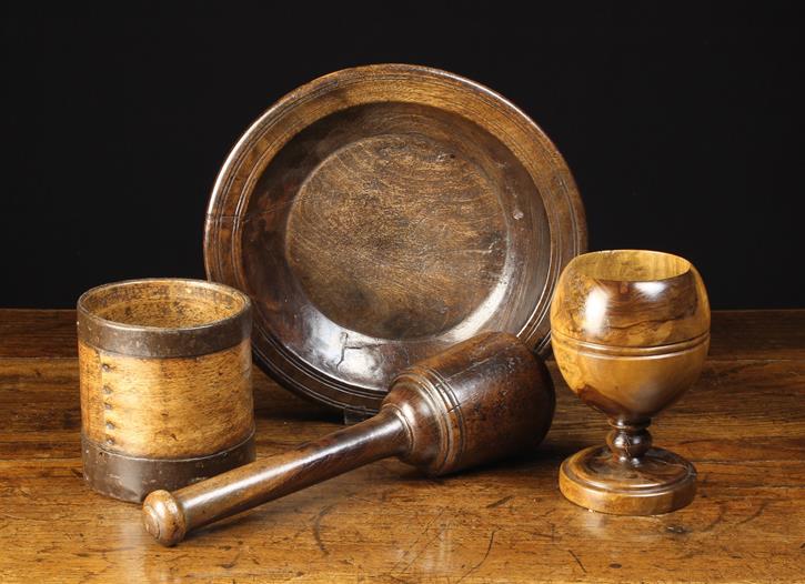 Four Pieces of Antique Treen: An 18th century turned lignum pestle 12½" (32 cm) in length.