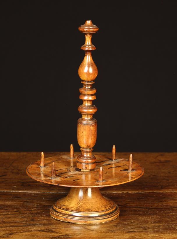 An 18th Century Turned Fruitwood Cotton Reel Stand with elaborately turned centre stem screwing