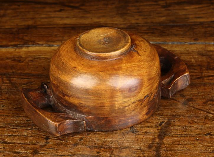 A 19th Century Fruitwood Quaich. The turned bowl with raised foot and pierced lug handles, 1¾" (4. - Image 2 of 2