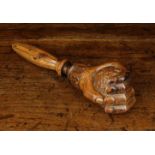 A Charming 19th Century Carved Fruitwood Nut Cracker in the form of a hand clenched around the nut