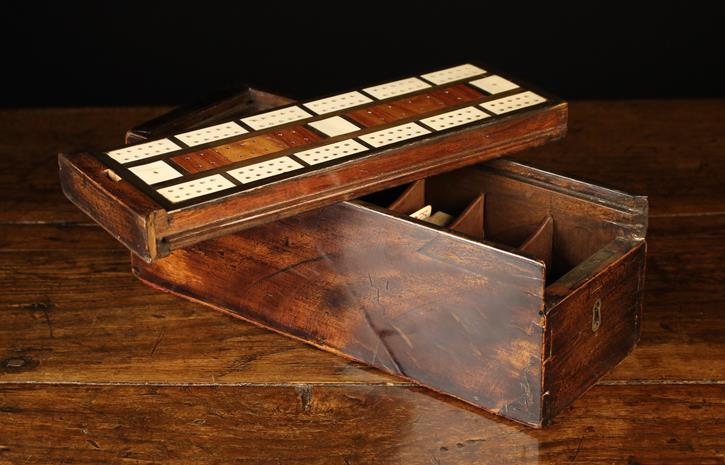 A 19th Century Mahogany Games Box of rectangular form with a brass lined keyhole to one end.