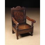 A Late 17th Century Child's Joined Oak Armchair with marquetry panel back and a hump topped