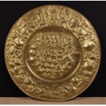 A Large Early 19th Century Repoussé Brass Charger embossed with an allegorical scene to the centre