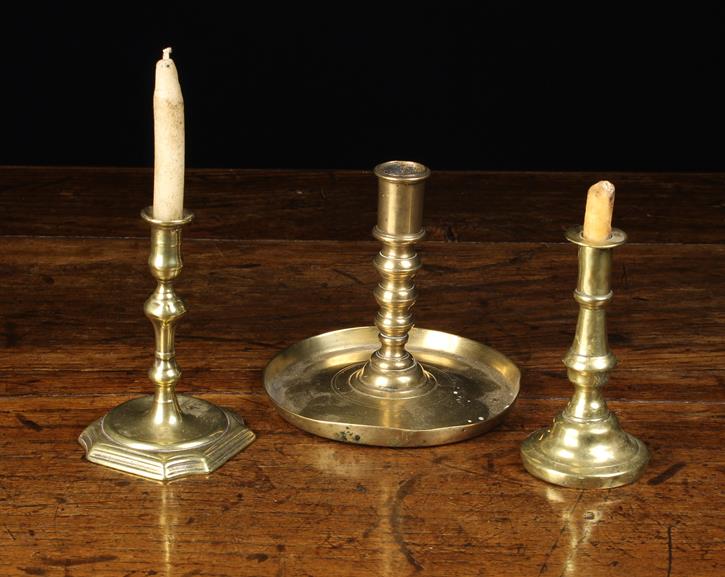 A 17th Century Spanish Brass Candlestick with turned socket above graduated triple knopped stem