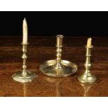A 17th Century Spanish Brass Candlestick with turned socket above graduated triple knopped stem