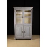A Late 19th Century Grey Painted Pine Cabinet with a moulded cornice above glazed door to the upper