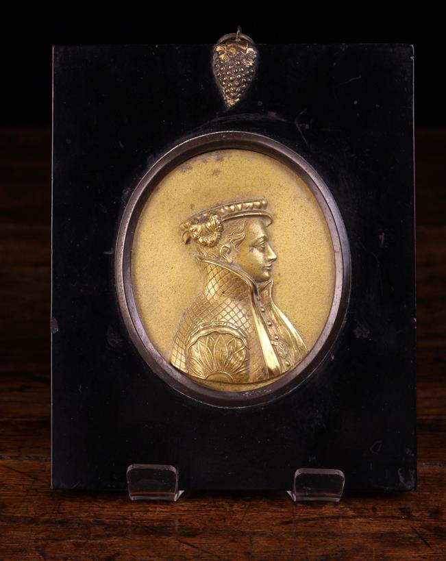 A Small 19th Century Gilt Bronze Oval Plaque relief cast in intricate detail with profile bust of