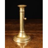 A Large 19th Century English Brass Ejector Candlestick having a flared candle nozzle to the