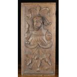 A 16th Century Style Oak Panel carved with portrait bust of a gentleman above a fanned spray of