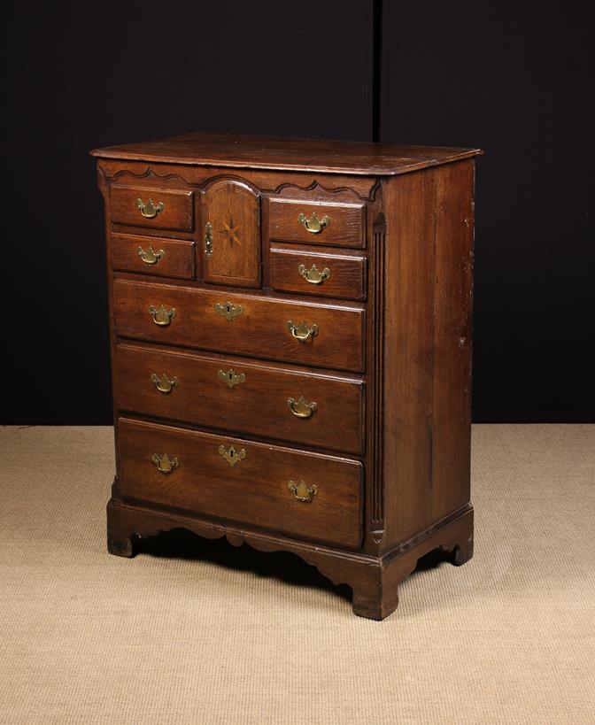 A Fine 18th Century Norfolk Chest of Drawers incorporating a small cupboard.