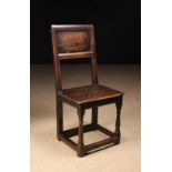 A Late 17th/ Early 18th Century Joined Oak Side Chair with a high back panel in a chamfered frame