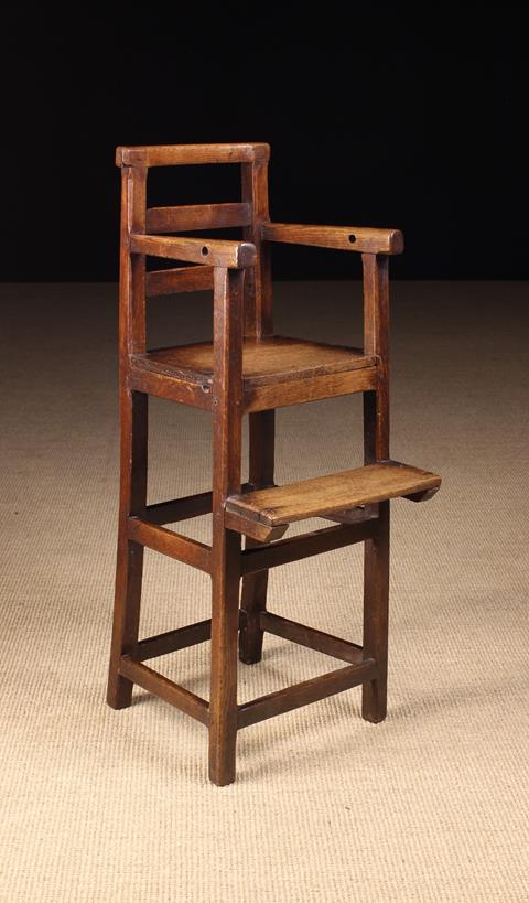A Late 18th/Early 19th Century Joined Oak Child's High Chair with bar back and solid seat on tall
