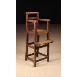 A Late 18th/Early 19th Century Joined Oak Child's High Chair with bar back and solid seat on tall