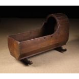 A Late 18th Century Oak Cradle, having a domed hood and curved wooden rockers, 26¾" (68 cm) high,