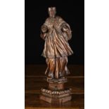 A Small 16th Century Carved Wooden Statuette of a caribinal wearing a biretta,