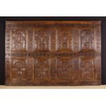 A Section of 17th Century Carved Oak Panelling configured in two rows of four arcaded panels.