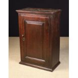 A Fine 18th Century Welsh Joined Oak Cupboard having a moulded top above a fielded panel door with