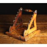 A 19th Century Mahogany Quill Rack mounted on a square bevel edged base, 6¼" (16 cm) high, 6½" (16.