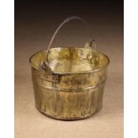 A Large 19th Century Brass Log Bucket with a copper bottom and an iron ropetwist swing handle