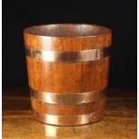 A 19th Century Coopered Mahogany Bucket bound in copper straps 13" (33 cm) high,