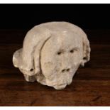 A Medieval Carved Stone Fragment Carving of a Head, 5" (12.5 cm) high, 5" (12.5 cm) wide.
