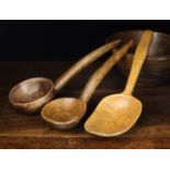 A 19th Century Sycamore Ladle with a round bowl on an integral handle with hook end,