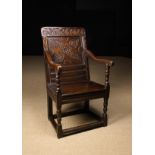 A 17th Century Oak Wainscot Chair. The top rail gouge carved with a band of undulating scrolls.