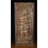 A 16th Century Oak Panel carved with depiction of Saint Clare in flowing robes standing within an
