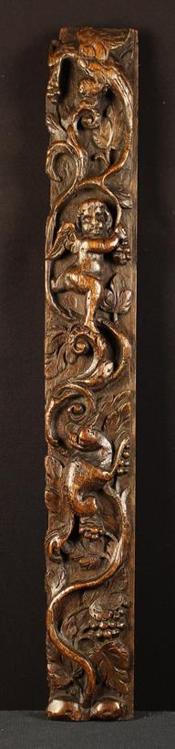 A Late 16th/Early 17th Century Carved Oak Term depicting undulating grape vine with cherubs,